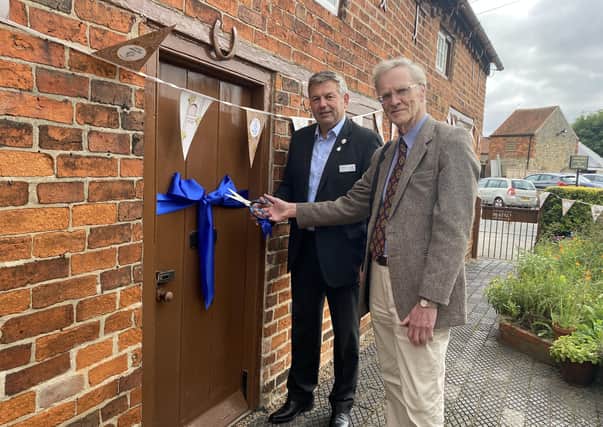 Coun Richard Wright and Malcolm Smith cutting the ribbon to Mrs Smith’s Cottage. EMN-210210-141045001