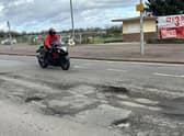 Potholes along the seafront are so deep they could kill, warns a former motorcyclist.