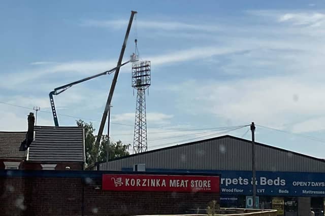 A crane and cherry picker beside one of York Street's floodlights.