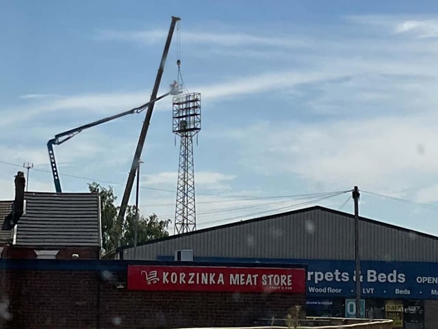 A crane and cherry picker beside one of York Street's floodlights.