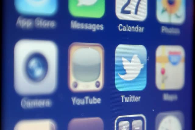 The logo of social networking website Twitter is seen displayed on the screen of an iPhone smartphone.
