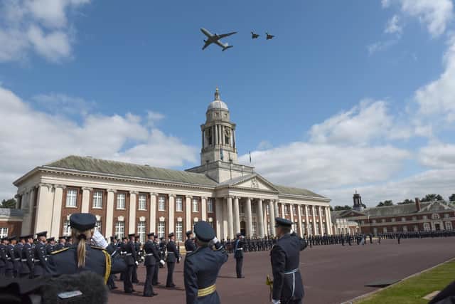 An RAF Voyager and two Typhoons fly over College Hall for the belated graduation parade.