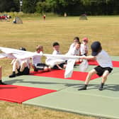 Children joining in a tug of war game at the Community Games Day.
