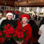 Volunteers with Poinsettias donated by Bells Nurseries (from left) Sarah MacDonald, Leah Donovan and  Deborah Bartholomew