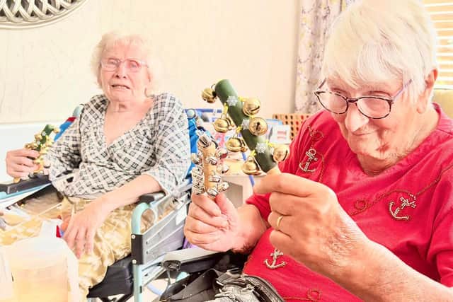 Residents playing bells at HC-One’s Elmwood House Care Home performing in home orchestra