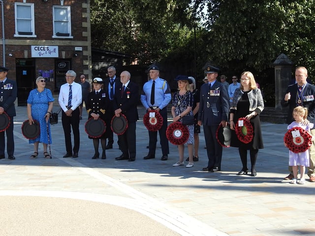 Civic dignitaries and military representatives wait to lay their wreaths.