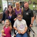 Xander Poulson after the haircut with family and Richard Burke.