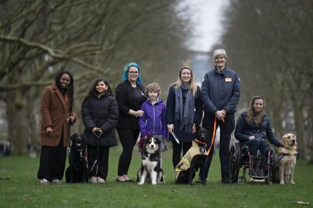 Freya Harris with mum Gemma (centre) with The Kennel Club Hero Dog Award 2024 finalists. Photo: BeatMedia/Kennel Club