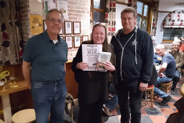 The 2025 Good Beer Guide. L to R, Malcolm Phillips, Chairman of Fenland Branch, Jackie Clarkson landlady of the Eagle, Pete Hopwell of Castle Rock Brewery.