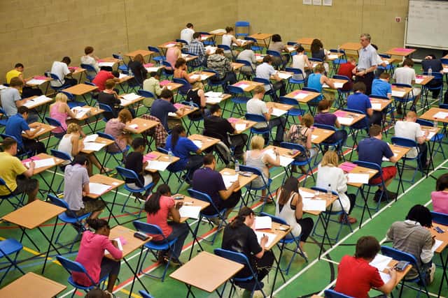 File photo dated 25/05/10 of students sitting an exam, as the Higher pass rate is down from last year but remains above 2019 levels, as more than 140,000 pupils across Scotland receive their exam results.