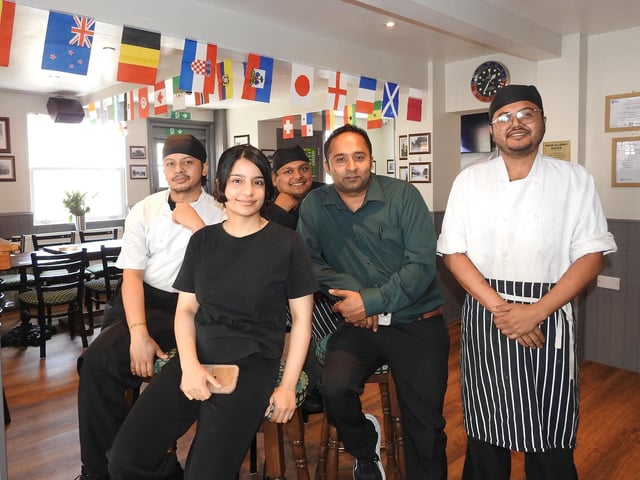 The team at The Barracks Inn, with the dining area behind.
