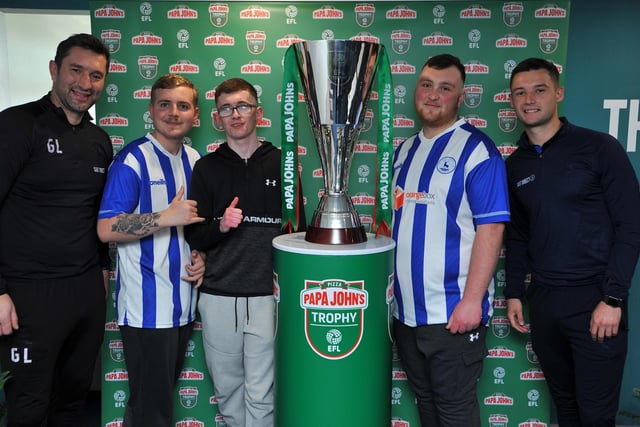 Pools fans (left to right) Jack Egglestone, Aiden Field and Morgan Buck pose for a photo with Graeme Lee (left) and Luke Molyneux (right).