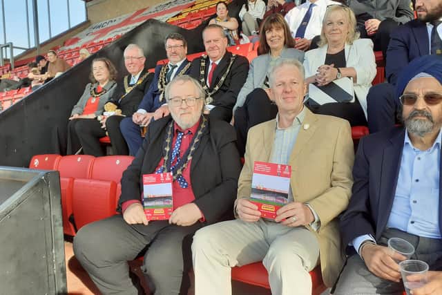 Sleaford's Deputy Mayor Coun David Suiter (left) and former mayor Coun Robert Oates join the crowd supporting the charity memorial match at Lincoln City.