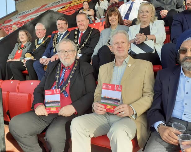 Sleaford's Deputy Mayor Coun David Suiter (left) and former mayor Coun Robert Oates join the crowd supporting the charity memorial match at Lincoln City.