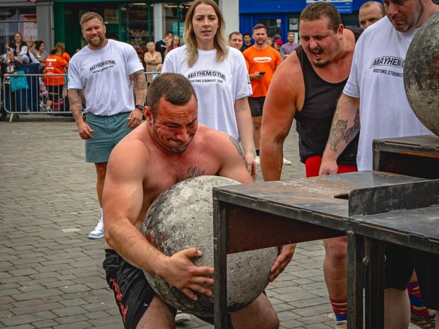 Tom Dust, of Boston, grappling a 140kg atlas stone.