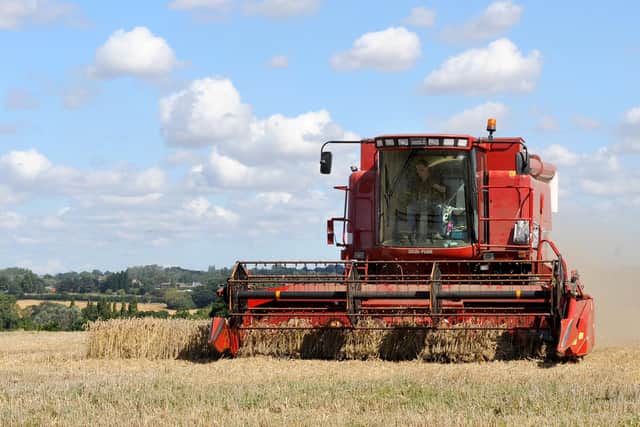 Stock. A combine harvester works in a wheat field, near Mountnessing, in Essex. PRESS ASSOCIATION Photo. Picture date: Friday August 15, 2008. Photo credit should read: Ian Nicholson/PA
