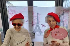 Residents posing in front of the Eiffel Tower.