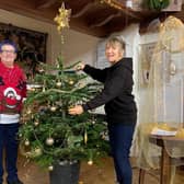 Sue Alldred, Polly Butler and Carole Harbon decorate the Bell's Christmas Tree ready for community lunch in  Wainfleet.