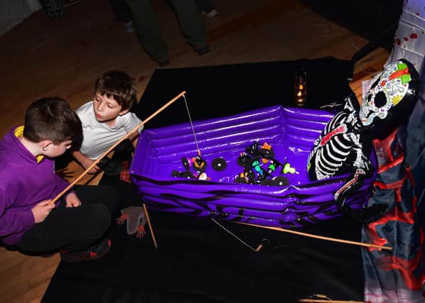 Albie and Reuben ‘fishing for prizes at Woodhall Spa Lions' Halloween event .Photos: Mick Fox