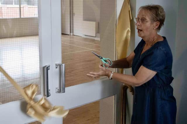 Jenny Harrison cuts the ribbon.