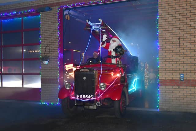 Santa makes his gran exit from the fire station.