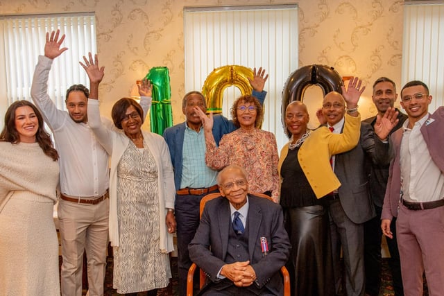 Members of Ralph's family, helping him mark his 100th birthday.
