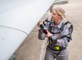 BAE Systems apprentice Alisha Wherrit demonstrates the new Exoskeleton.