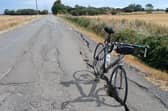 Chris' bike propped up in the deep crack on the road surface at Thorpe Bank, Spilsby.