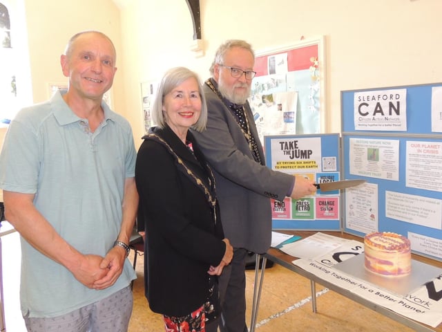 Cutting the anniversary cake - L-R - Tim Grigg of Sleaford Repair cafe, Deputy Mayor Alison Snookes and Mayor David Suiter.