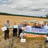 The campaign group with Coun William Gray (third left) and Sir Edward Leigh (fourth right) at the site of the proposed solar farm.