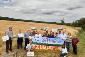 The campaign group with Coun William Gray (third left) and Sir Edward Leigh (fourth right) at the site of the proposed solar farm.