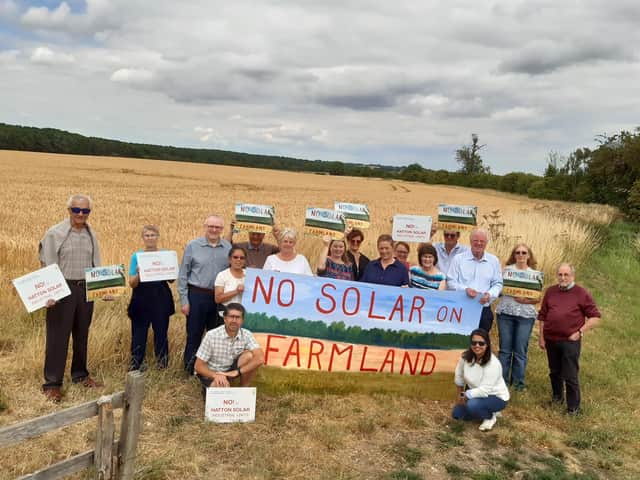 The campaign group with Coun William Gray (third left) and Sir Edward Leigh (fourth right) at the site of the proposed solar farm.