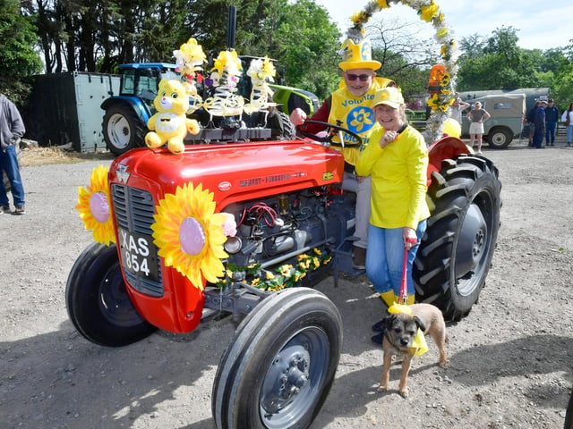 Embracing the yellow theme of the Wolds Tractor Run are Peter Kipling and Win Gibney with dog Max, all of South Elkington.