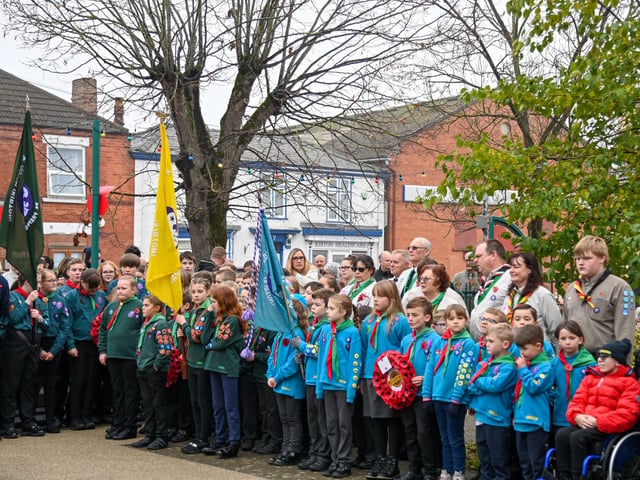 Members of the Kirton community pay their respects at the war memorial.