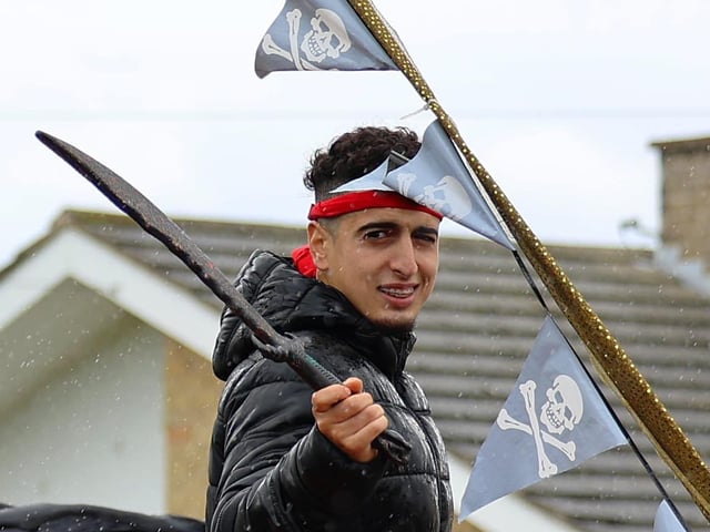 Smile or face the pirates in the carnival procession.