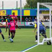 Sisa Tuntulwana rises highest to head Trinity's opening goal against Bottesford. Photo: Bryan Pye.