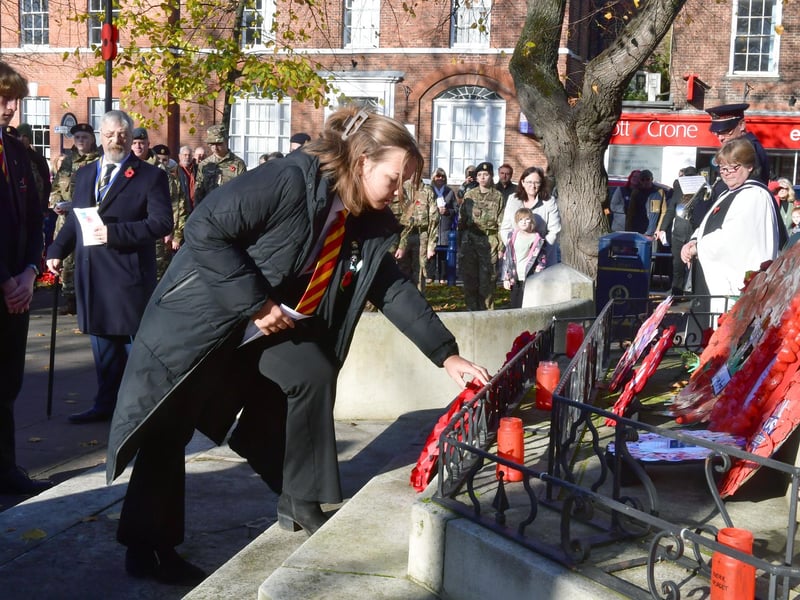 A local school pupil lays a wreath at the war memorial.