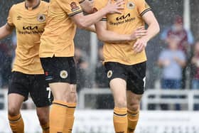 Jimmy Knowles is congratulated after scoring on Saturday. Photo by Tim Hoff.