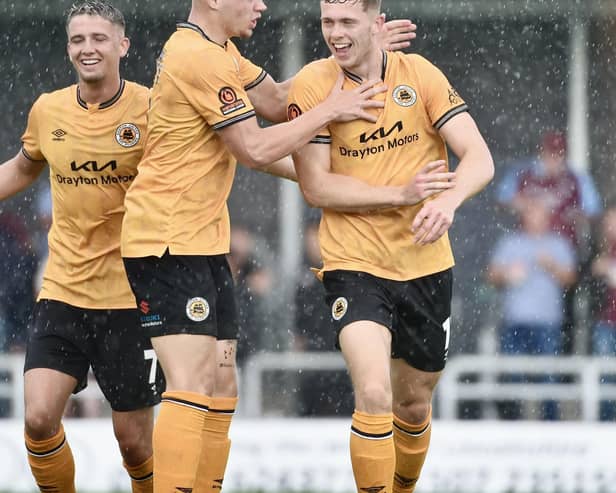 Jimmy Knowles is congratulated after scoring on Saturday. Photo by Tim Hoff.