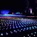 Sea Of Light - the dazzling Coldplay light show washes across the landscape in shimmering waves next to Belton House