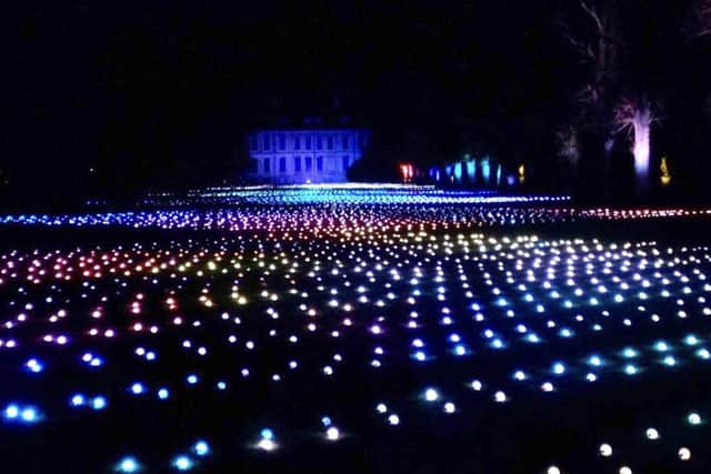 Sea Of Light - the dazzling Coldplay light show washes across the landscape in shimmering waves next to Belton House