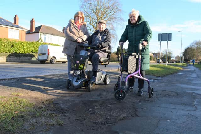 Brian and Norma Sales, with daughter Pauline Blaker, at one of the broken up areas of footpath