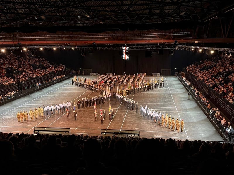 Skegness RBL chairman and Standard Bearer Kev Woolley leads out at Birmingham International Tattoo.