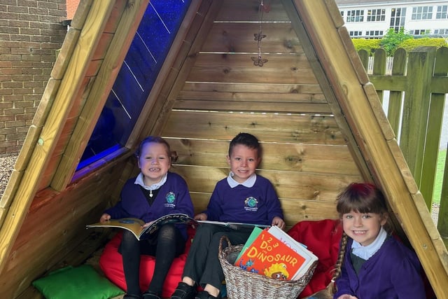 Horncastle Primary School in the new EYF outdoor area's reading corner. From left: Hettie Marshman, 4, Hudson Swain, 5, and Evie Williams, 5.
