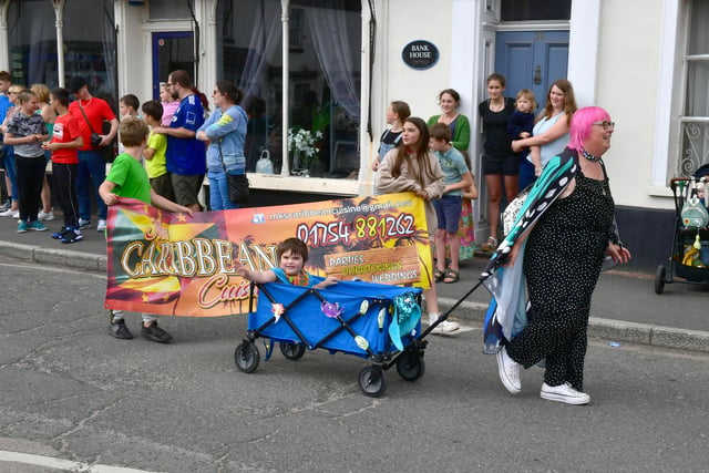 The parade passed the funfair that was in the town centre.