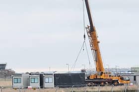 A crane removes portacabins at RAF Scampton