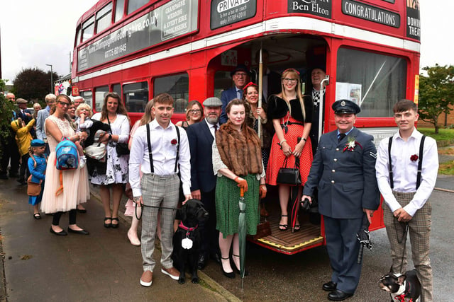Guests in 40s and 50s dress board the bus.