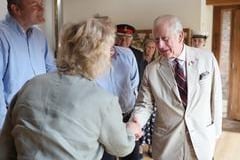 King Charles shakes hands on arrival at Ulceby Grange Farm near Alford.