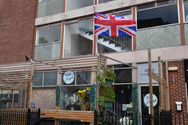 The Union Flag flying at half mast outside Cafe Noglish, in Bostob.