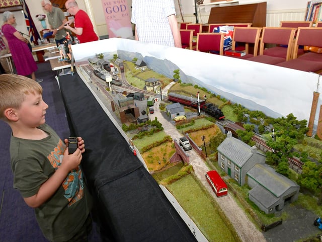 Charlie Creasey 5 looking at a Riverside Model Club display in Riverside Church